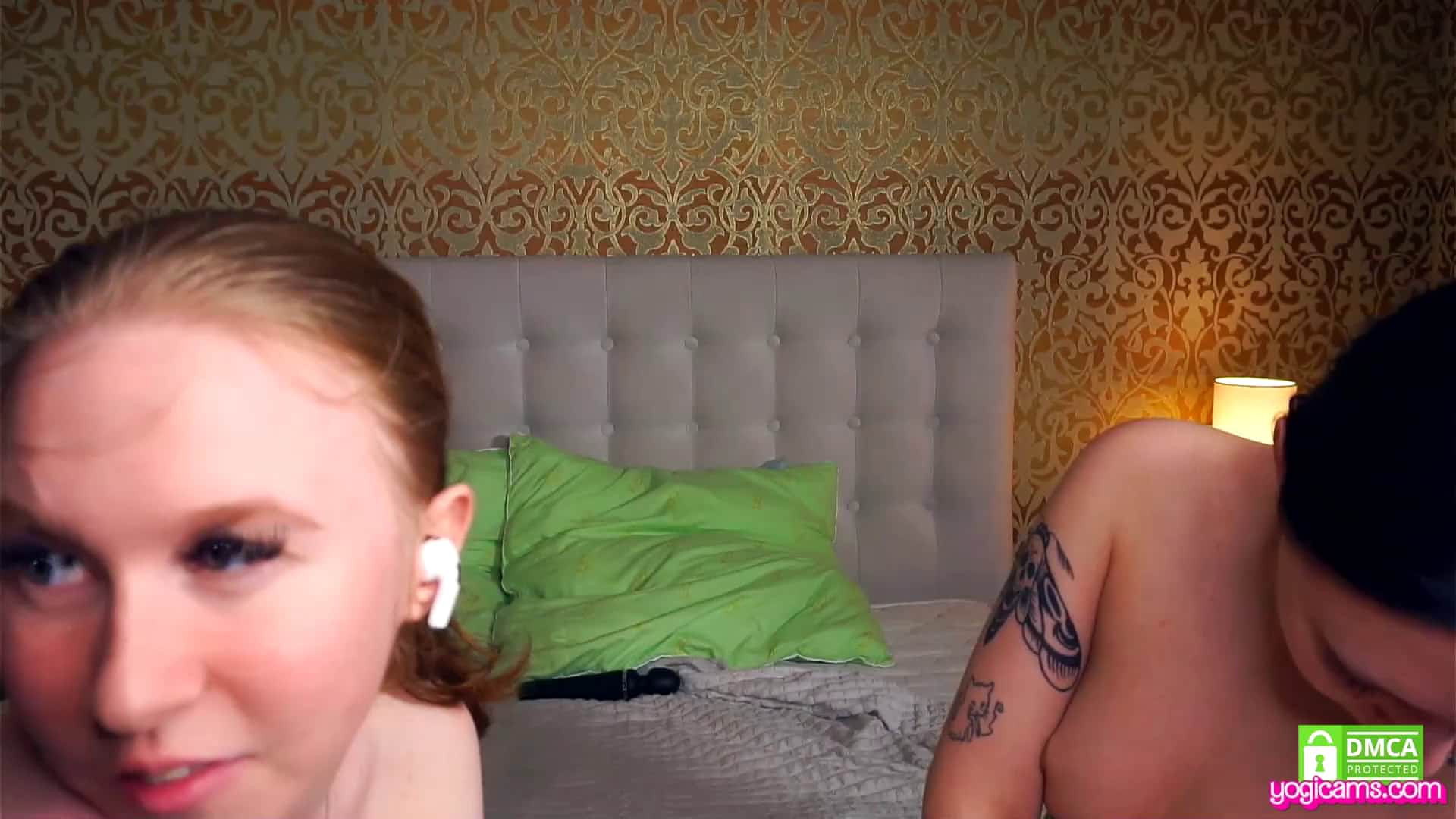 Steamy lesbians share an imminent kiss under the sheets while showing off their naked bodies